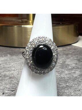 Black onyx stone encased wit CZ type mini stones on .925 sterling silver band, s